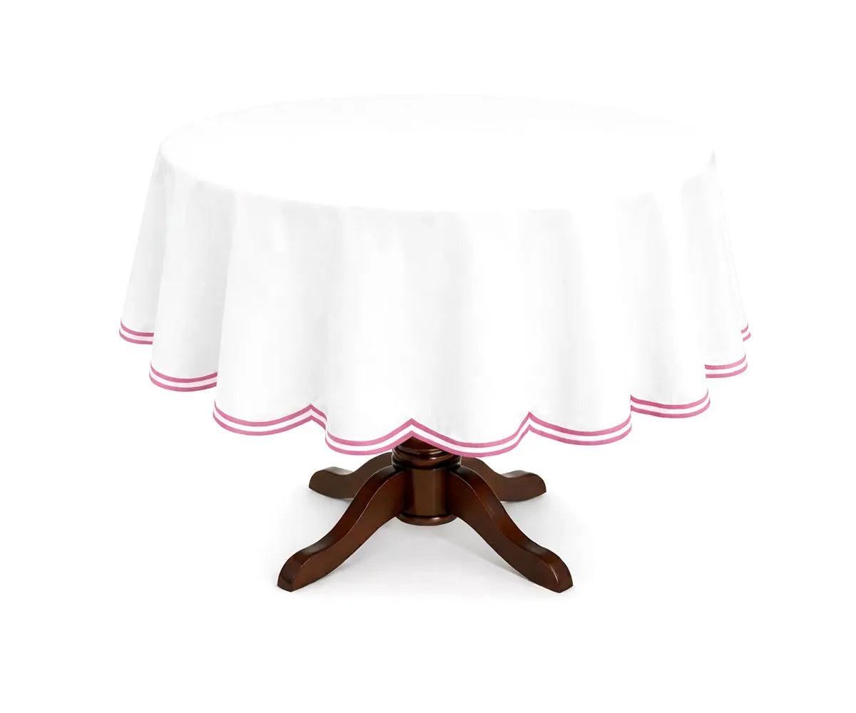 Pink round cotton tablecloth featuring a graceful double scalloped edge and lightweight cotton fabric. Designed for round tables, it brings a soft, inviting look to brunches, family meals, and celebratory gatherings.