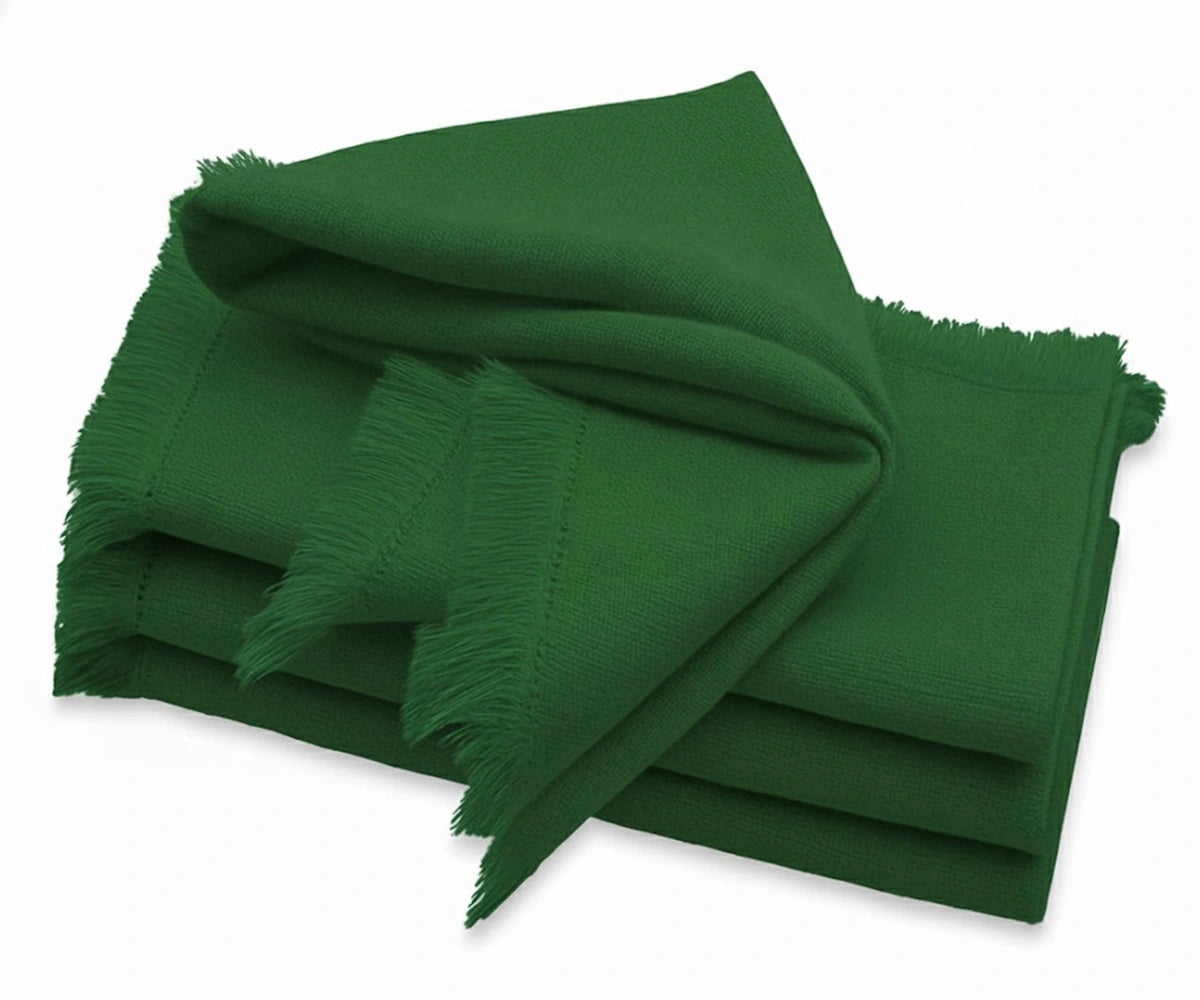 Christmas green cotton napkin with soft fringe edges on festive dining table