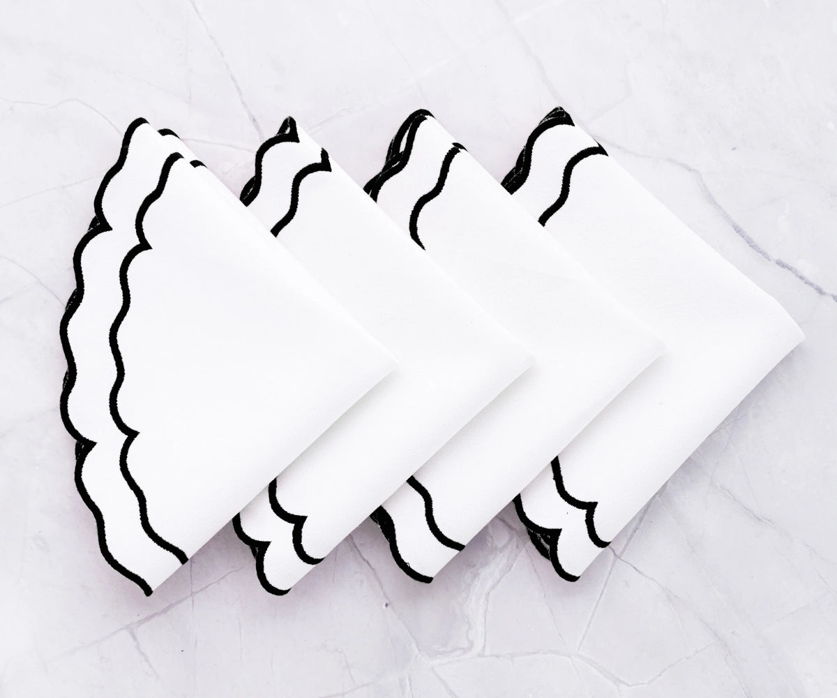 Stylish black and white cloth placemats for modern table setup