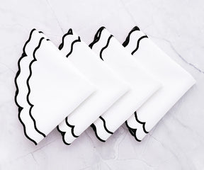 Stylish black and white cloth placemats for modern table setup