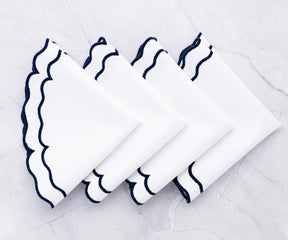 Soft navy and white cloth placemats bringing a modern coastal feel