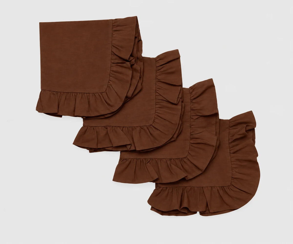 Set of four folded coffee brown cloth napkins featuring decorative ruffled edges