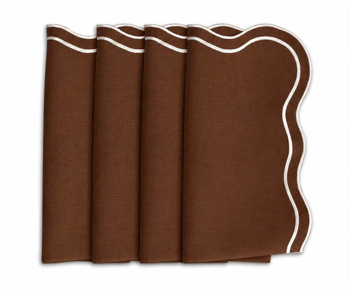 Set of four coffee brown dinner napkins featuring contrasting white scalloped embroidered borders