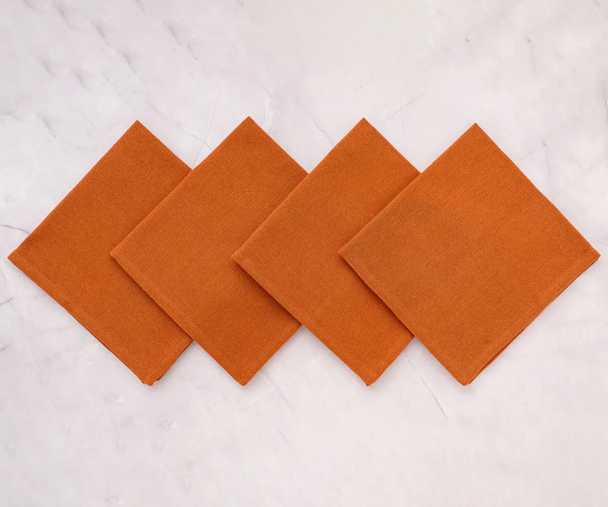 Stacked coral cotton cloth napkins for restaurant or home use – durable, machine washable, and stylish for everyday dining.