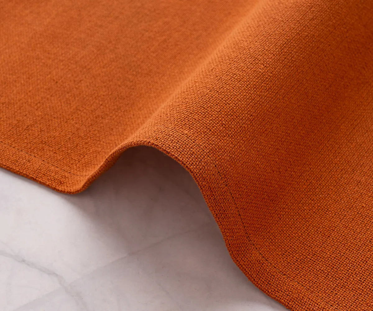 Vibrant coral dinner napkins with seasonal table décor – complements wooden chargers, runners, and centerpieces for a complete table setting.