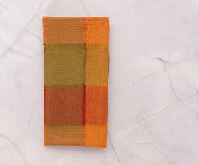 Reusable 100% cotton dinner napkins in orange, brown, and beige