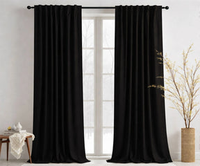 Black cotton curtains hanging in a modern living room
