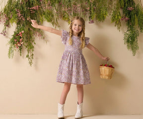 Cute toddler girl dress in floral print cotton fabric, styled with white boots and flower basket