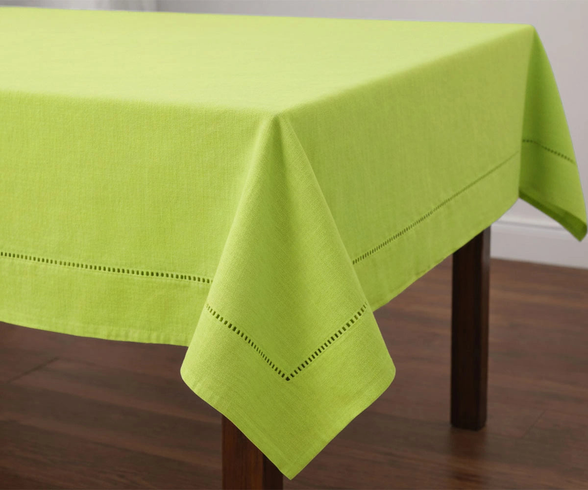 Solid green cotton tablecloth with stitched hem