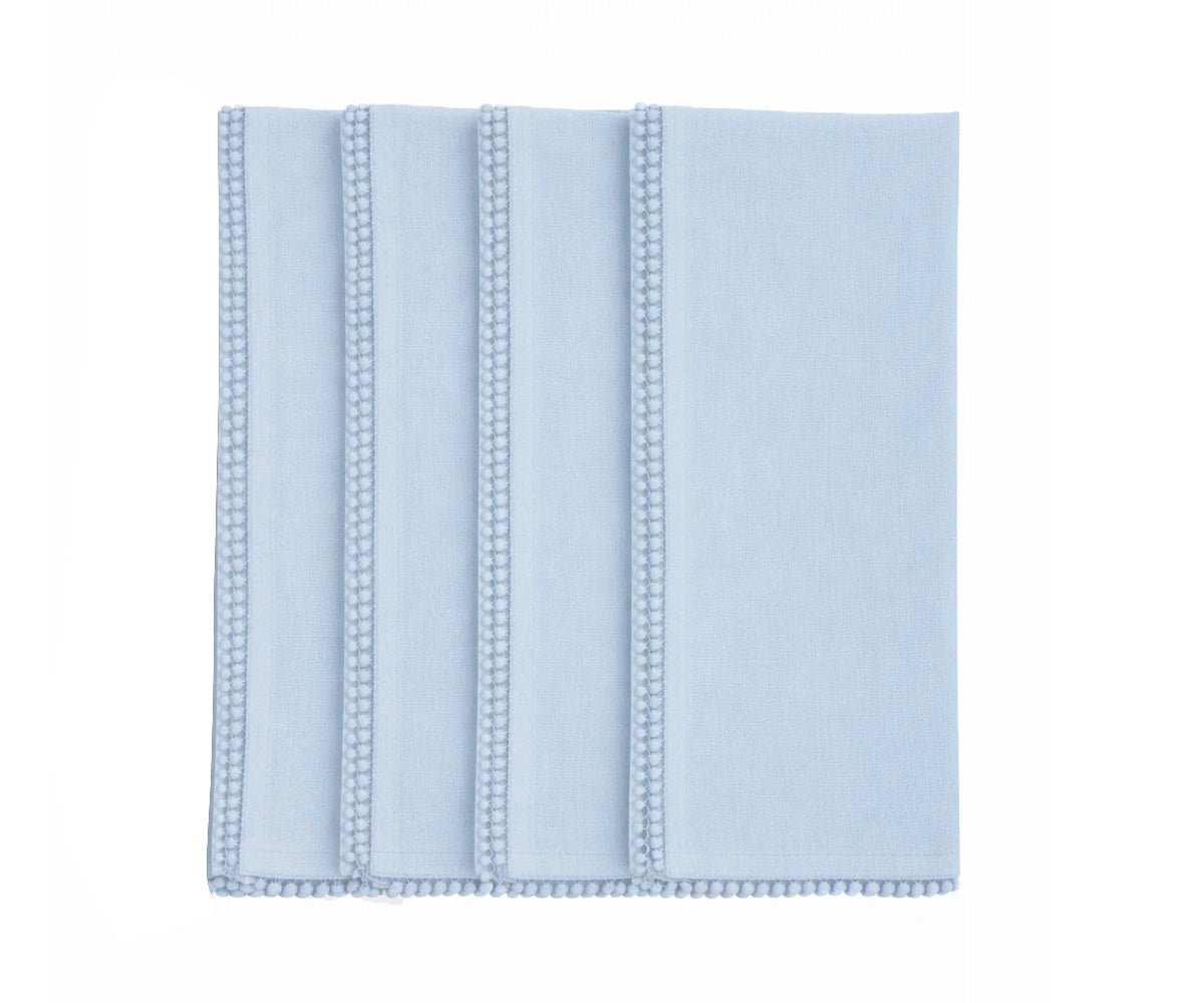 Light blue cotton napkin with pom pom edge detail