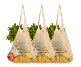 Cotton string bags brimming with fresh produce arranged on a table, mesh gift bags with drawstring