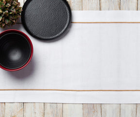 Black and white themed table setting featuring a white dinner napkin