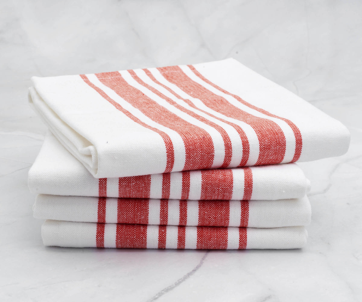 Four kitchen towels with red stripes stacked for display