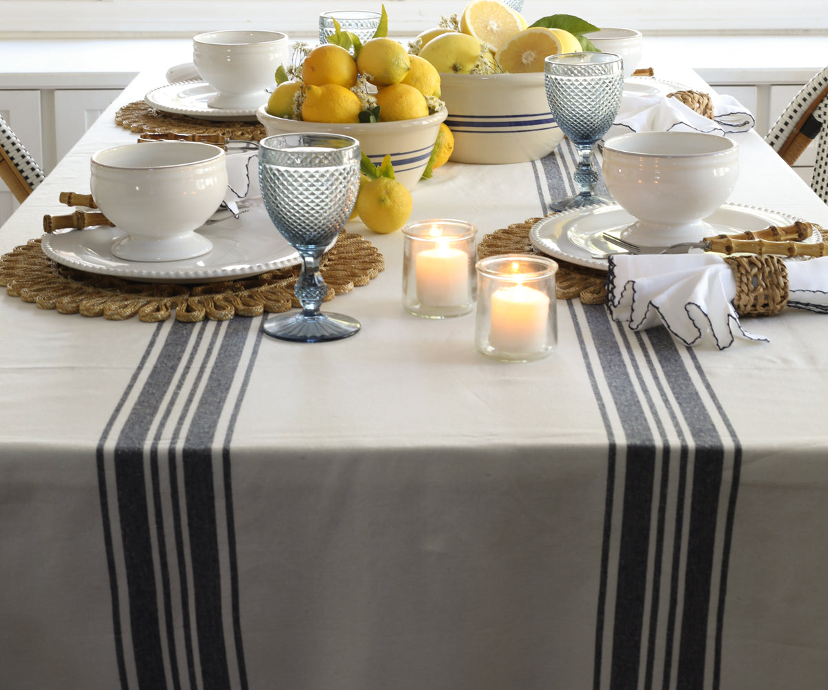 These striped cotton tablecloths typically have alternating bands of colour running horizontally or vertically across the fabric, creating a striped pattern. 
