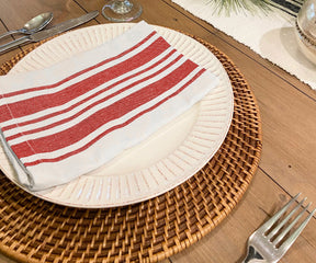 Set of red and white striped napkins on a festive dining table.