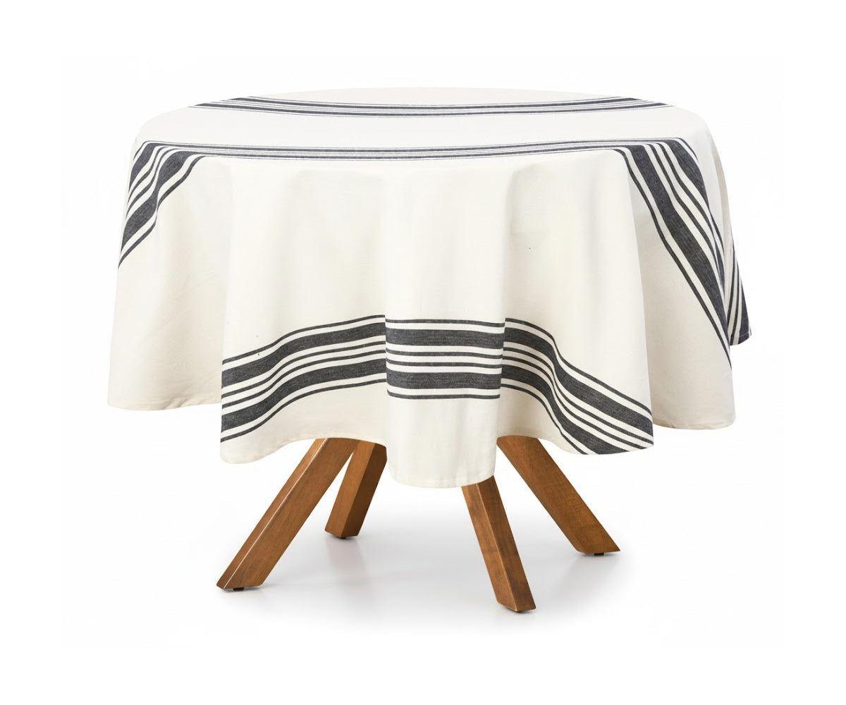 Round table with a striped tablecloth on a white background