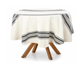 Round table with a striped tablecloth on a white background