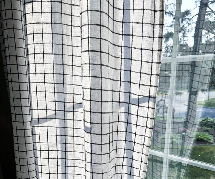 white checkered curtain with black checks in window side out view.