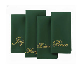 Set of dark green embroidered cotton napkins with festive words Joy, Merry, Peace, and Believe, perfect for holiday dinners and seasonal gatherings