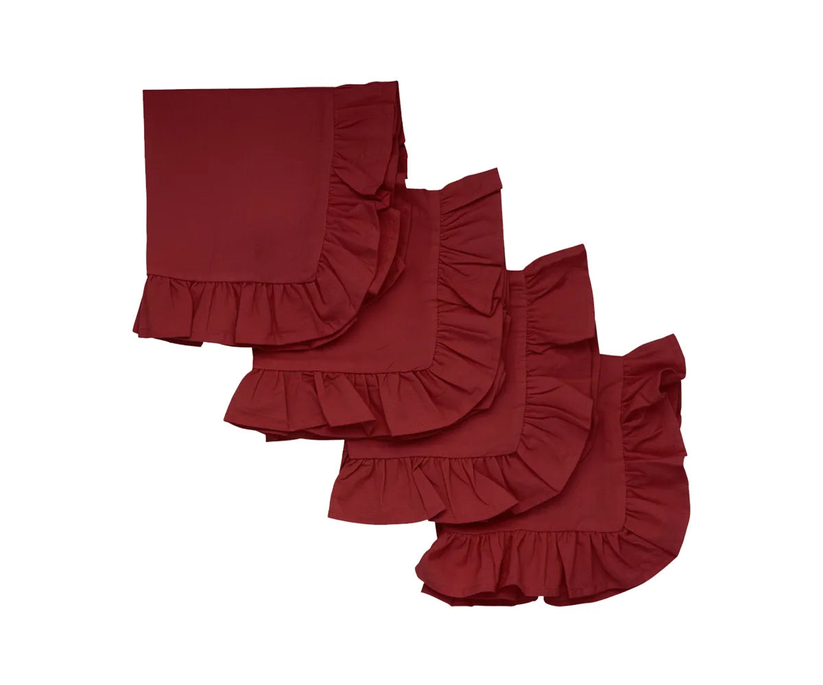 Dark red cotton napkins with ruffle edges  on dining table
