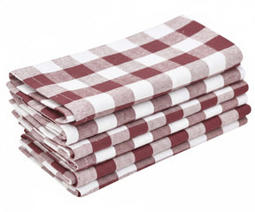 Stack of dark red and white checked cotton table napkins folded neatly