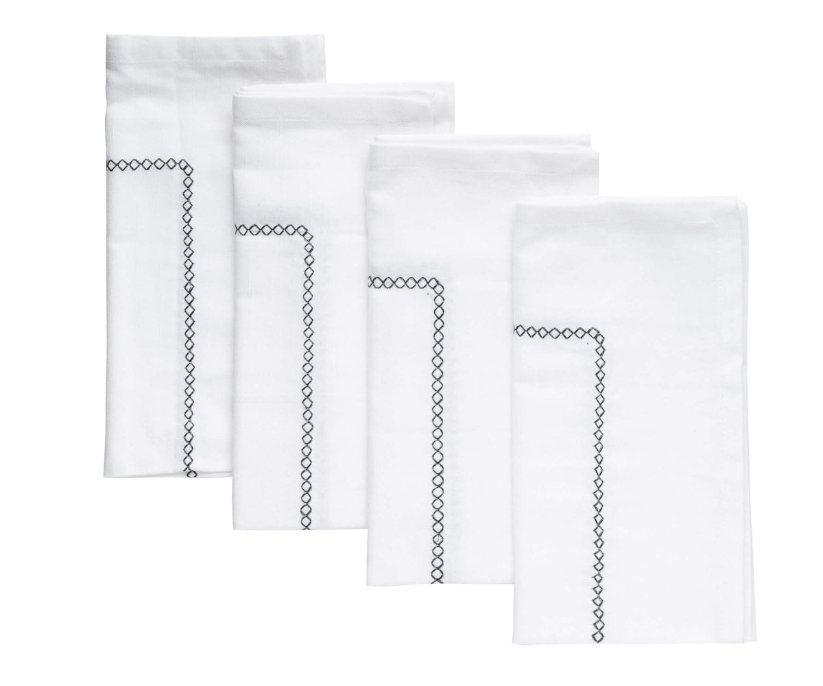 The gray dinner napkins provide a sense of freshness and purity to the table setting.