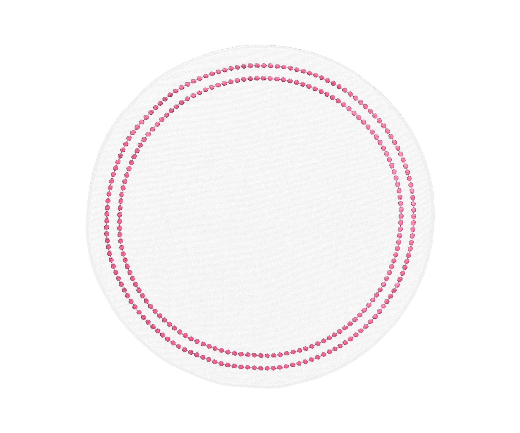 Round peony cotton placemat with embroidered floral design and dot trim on a dining table