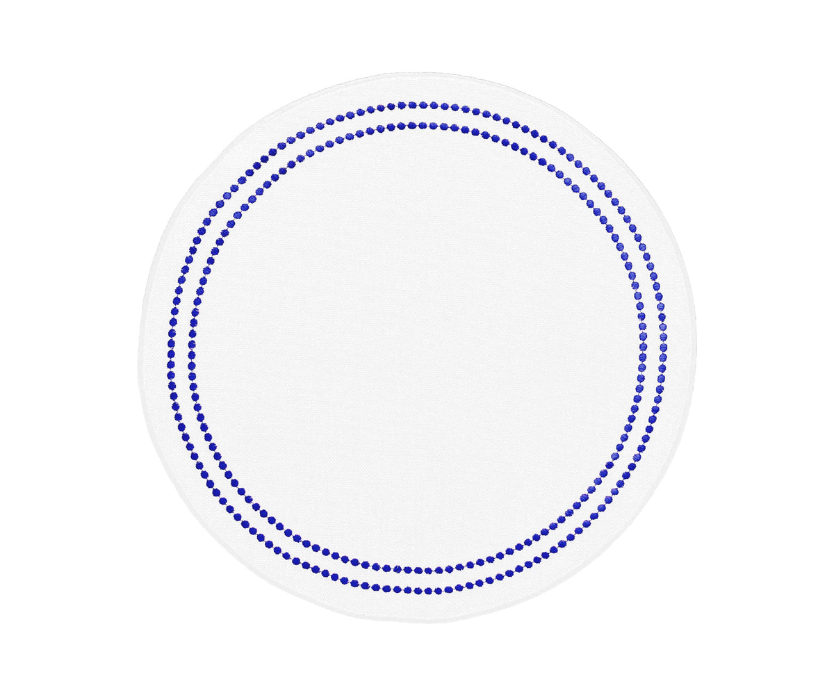 Royal blue round cotton placemats with delicate embroidery and pearl-inspired accents for elegant dining tables.
