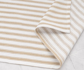 Cozy beige striped cotton towels paired with matching table linens
