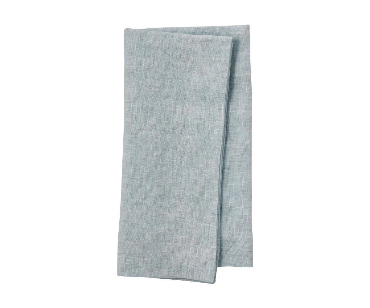Dusty blue plain linen napkin folded, showing muted pastel tone and fine linen weave
