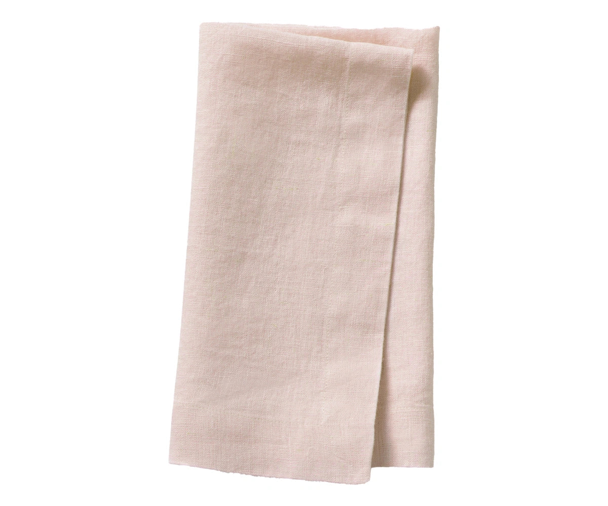 Dusty rose plain linen napkin arranged for table setting, soft romantic fabric texture