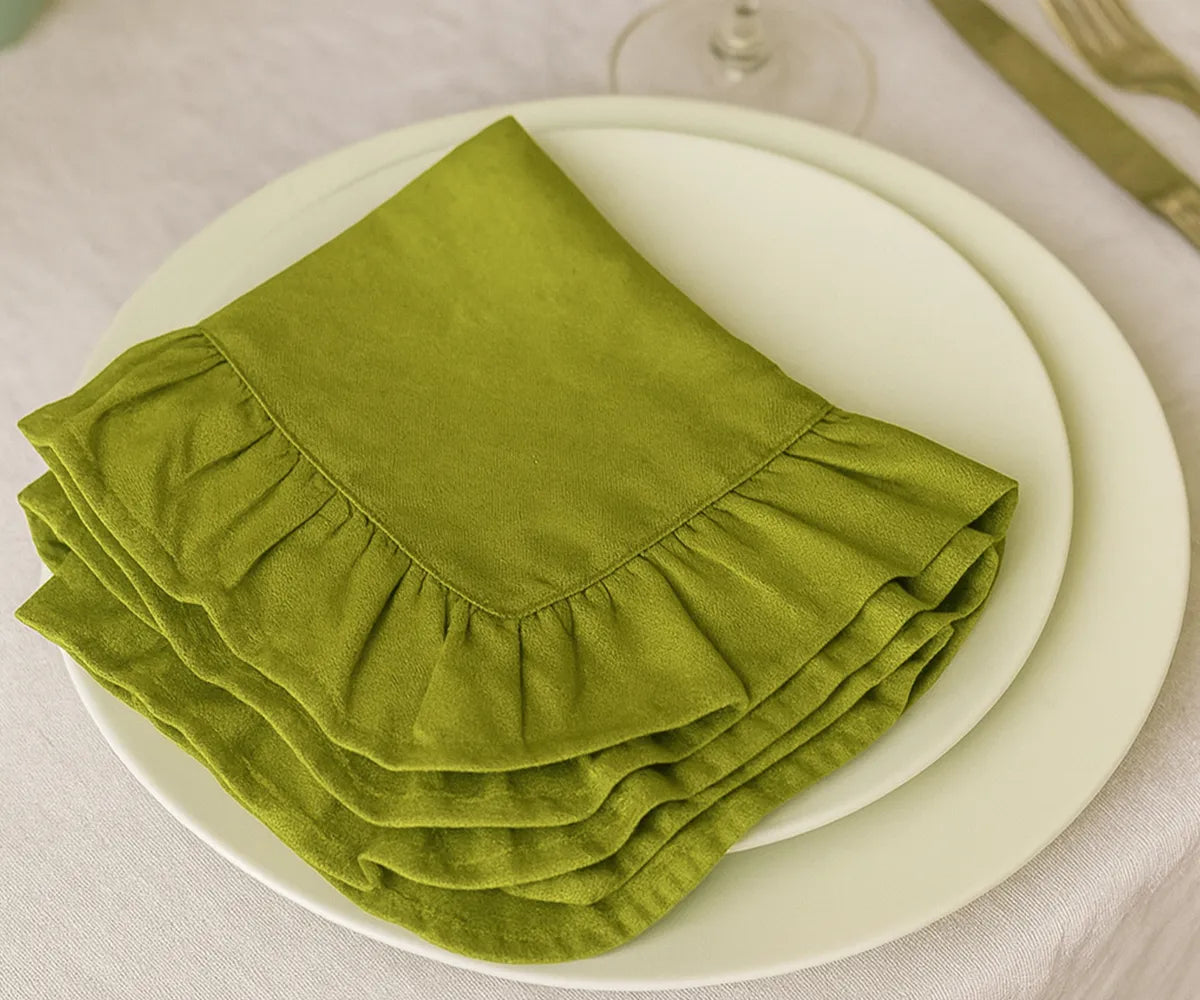 Set of eco-friendly green ruffled cloth napkins made from 100% cotton, durable and absorbent fabric napkins available in bulk or small sets, perfect for everyday dining and festive gatherings.