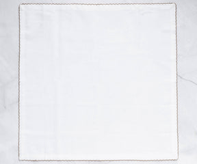 Single white napkin with gold shell embroidery and elegant border