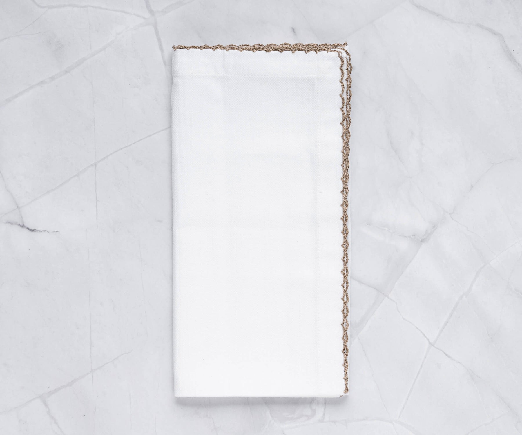 Luxurious shell edge napkin adorned with a gold trim