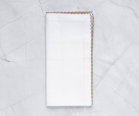 Luxurious shell edge napkin adorned with a gold trim