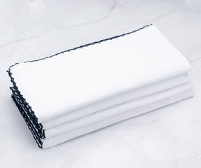 Set of four shell edge napkins with chic black detailing