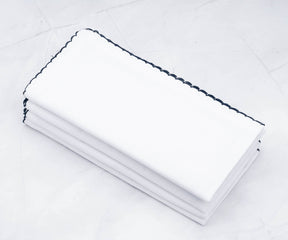 Multiple shell edge cloth napkins with a sleek black edge