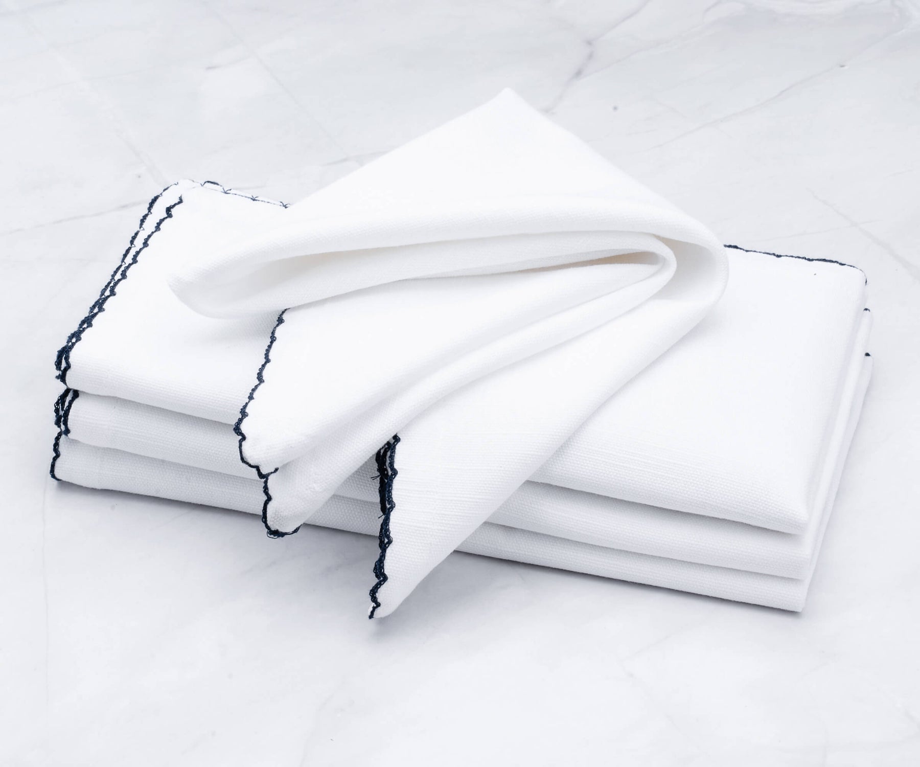 Bulk of shell edge napkins featuring a classic black border