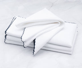Bulk of shell edge napkins featuring a classic black border
