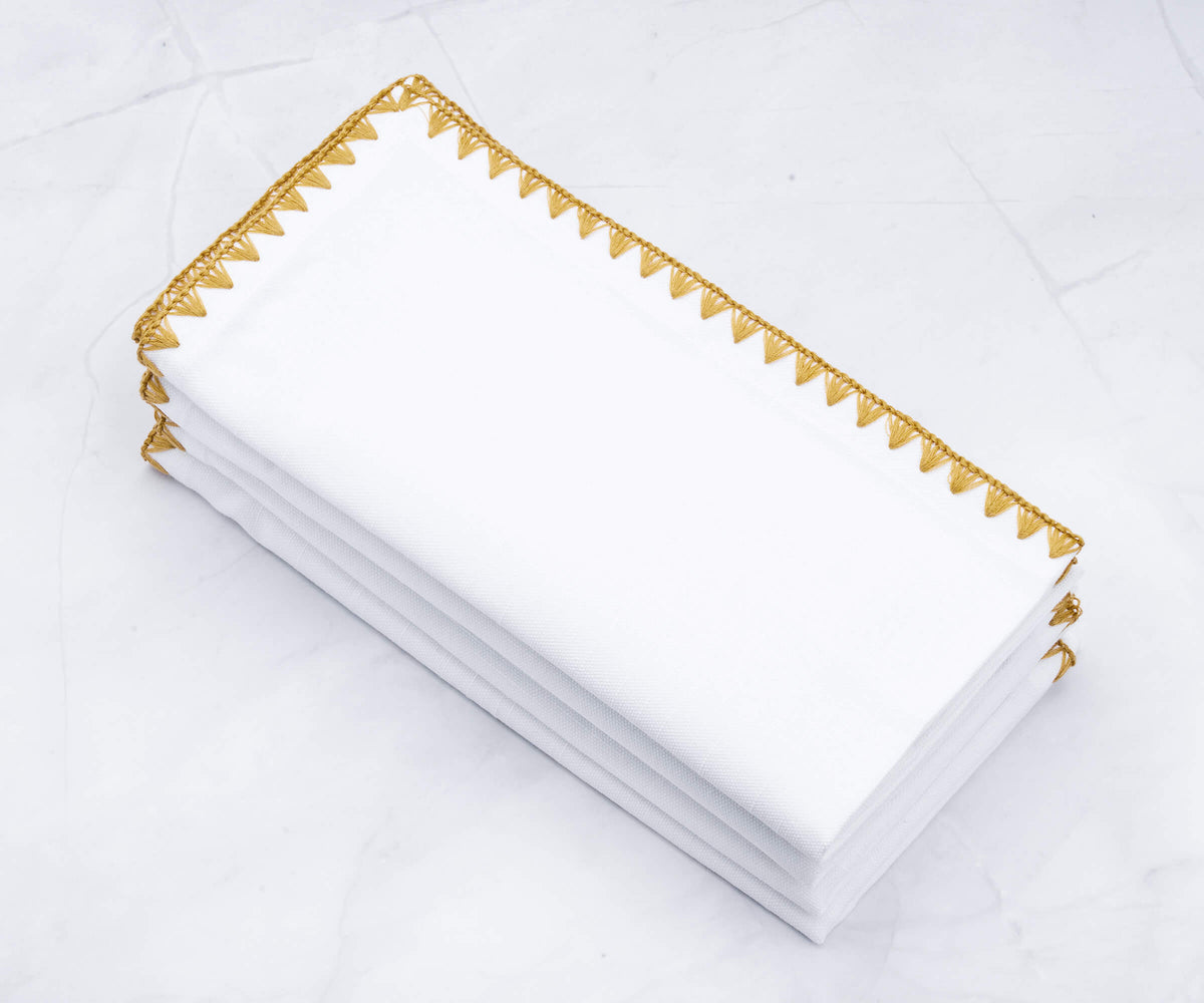 Elegant white wedding napkin featuring a shell edge and gold trim