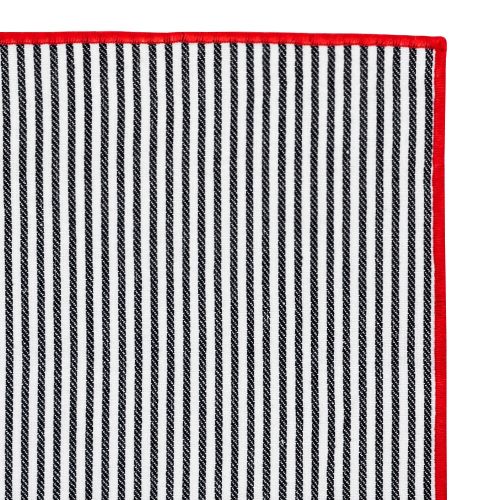 Stylish black and red striped napkin folded creatively for a sophisticated dinner presentation.