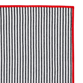 Stylish black and red striped napkin folded creatively for a sophisticated dinner presentation.