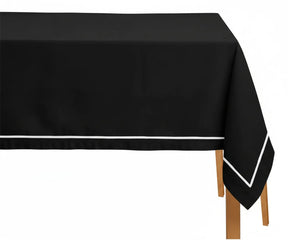 Black rectangle cotton tablecloth with white embroidered pattern on formal dining table