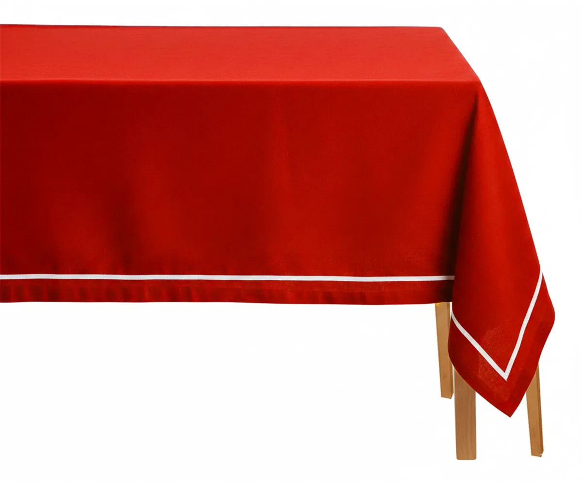 Red rectangular cotton tablecloth with white embroidered design on dining table