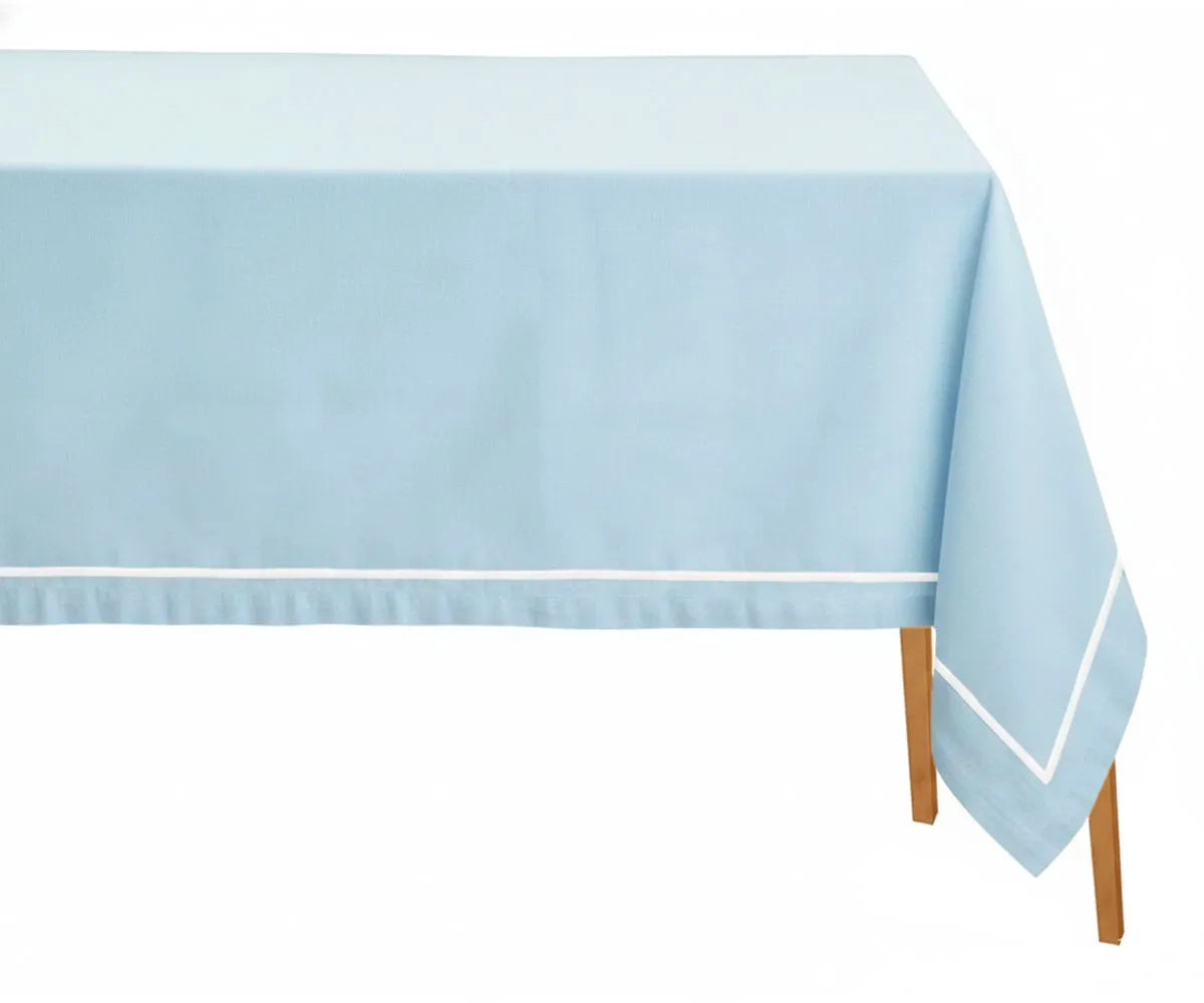 Light blue embroidered rectangular cotton tablecloth with white embroidery on dining table