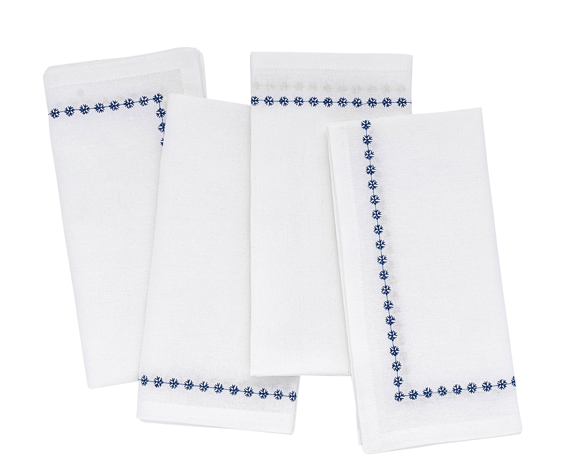 Set of four white napkins with blue floral embroidery on a white background