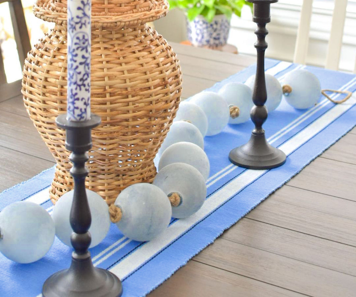 Country striped farmhouse table runner on a rustic dining table.