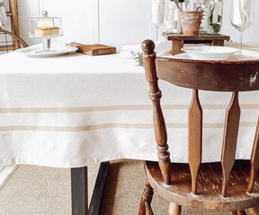 Wooden chair on a French tablecloth draped over a table and Farmhouse Style Linen Tablecloth for Rectangular Tables