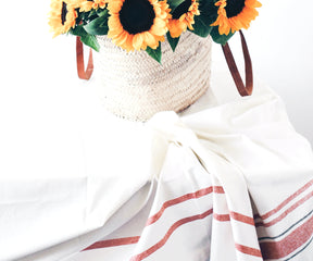 Basket of sunflowers on a French tablecloth. Elegant Linen Tablecloth for Rectangle Tables.