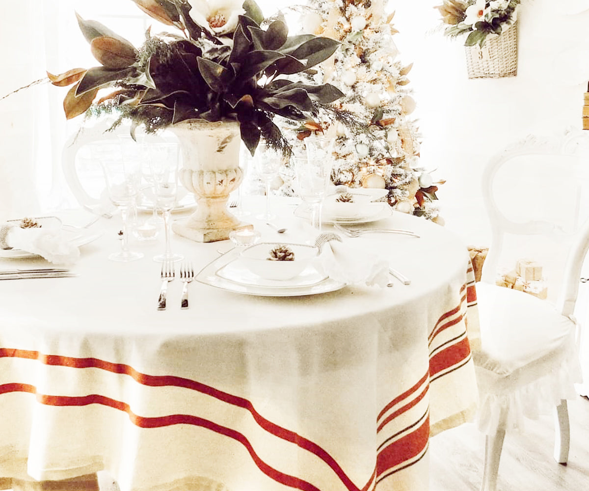Cotton talecloth - Christmas dinner setting on a French tablecloth with a Christmas tree in the background